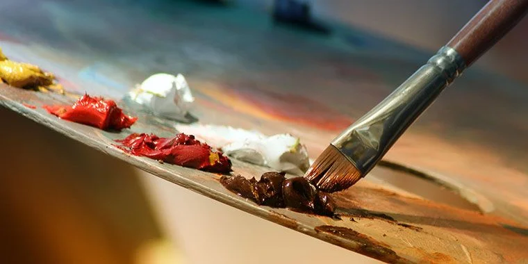 Artist palette with brush and oil paints