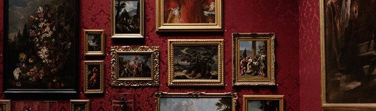 Wall of framed old paintings