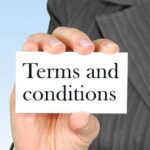 Hand holding card with printed Terms and conditions